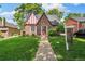 Charming brick Tudor-style home with inviting front yard and manicured lawn at 3055 N Albion St, Denver, CO 80207