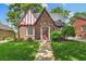 A charming brick home with a red trim, well-kept lawn, and inviting walkway at 3055 N Albion St, Denver, CO 80207