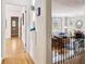This well-lit hallway provides access to the living room with a brick fireplace and large windows for natural light at 3055 N Albion St, Denver, CO 80207