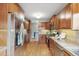 Spacious kitchen with stainless steel refrigerator, tiled backsplash, plenty of storage, and hardwood floors at 3055 N Albion St, Denver, CO 80207