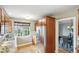 The kitchen features a stainless steel refrigerator, hardwood floors, and a large window for plenty of natural light at 3055 N Albion St, Denver, CO 80207