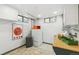 Well-lit laundry room featuring a stacked washer/dryer and ample counter space at 3055 N Albion St, Denver, CO 80207