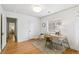 Bright office space featuring hardwood floors, textured walls, and a large window at 3055 N Albion St, Denver, CO 80207