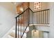 Staircase featuring wooden steps, iron railing, and neutral wall colors at 3055 N Albion St, Denver, CO 80207