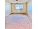 Bright bedroom with tan walls, window, ceiling fan, and neutral carpet at 605 S Alton Way # 7A, Denver, CO 80247