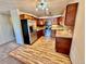 Kitchen featuring stainless steel appliances, wood cabinets, and wood grain flooring at 605 S Alton Way # 7A, Denver, CO 80247