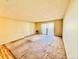 Bright living room with a sliding glass door leading to an outdoor balcony at 605 S Alton Way # 7A, Denver, CO 80247