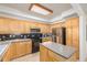 Well-lit kitchen showcasing wood cabinetry, stainless steel appliances, and a functional island at 1747 N Washington St # C306, Denver, CO 80203