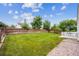Expansive backyard with pristine lawn, wood fencing, and room for recreational activities and entertainment at 11418 Macon St, Commerce City, CO 80640