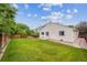 Well-maintained backyard featuring lush green grass, a privacy fence, and space for outdoor activities at 11418 Macon St, Commerce City, CO 80640