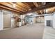 Unfinished basement with carpet flooring, exposed ceiling, and ample space for storage at 11418 Macon St, Commerce City, CO 80640