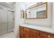 This bathroom features a large vanity, bright lighting, and a shower with sliding glass doors at 11418 Macon St, Commerce City, CO 80640