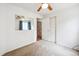 This bedroom features plush carpeting and has an exterior view through the window at 11418 Macon St, Commerce City, CO 80640