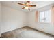 This bedroom features plush carpeting, a window for natural light, and neutral wall paint at 11418 Macon St, Commerce City, CO 80640