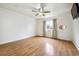 This bedroom features wood floors, a window for natural light, and a ceiling fan at 11418 Macon St, Commerce City, CO 80640