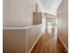 Hallway with hardwood floors, leading to living area at 11418 Macon St, Commerce City, CO 80640