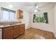 Bright kitchen featuring wooden cabinets, laminate counters, and a view of the backyard at 11418 Macon St, Commerce City, CO 80640