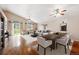Spacious living room with vaulted ceilings, ceiling fans, hardwood floors and large windows overlooking backyard at 11418 Macon St, Commerce City, CO 80640