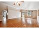 Bright and open living room featuring hardwood floors, neutral paint, and ample natural light at 11418 Macon St, Commerce City, CO 80640