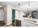 Modern kitchen with a large island, white cabinets and stainless steel appliances at 8839 Jackdaw St, Littleton, CO 80126