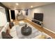 Finished basement with a comfortable sitting area and large TV at 3480 W 96Th Ave, Westminster, CO 80031