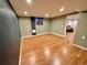 Finished basement with dark accent wall and wood floors at 3480 W 96Th Ave, Westminster, CO 80031