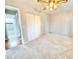Bedroom with carpet, ceiling fan, and adjacent bathroom at 3480 W 96Th Ave, Westminster, CO 80031