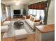 Bright living room with hardwood floors, comfy seating, and a large TV at 3480 W 96Th Ave, Westminster, CO 80031
