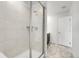 Modern bathroom featuring glass shower, tiled walls, and neutral color palette at 9022 Spaulding St, Parker, CO 80134
