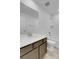Well-lit bathroom with a modern vanity, quartz countertop, and a tiled shower-tub combination at 9022 Spaulding St, Parker, CO 80134