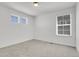 Bright bedroom with two windows providing natural light and plush carpeting at 9022 Spaulding St, Parker, CO 80134