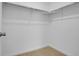 Walk-in closet with ample storage space and built-in shelving and hanging rods at 9022 Spaulding St, Parker, CO 80134