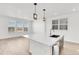 Bright kitchen with center island, pendant lights, and large windows offering scenic views at 9022 Spaulding St, Parker, CO 80134
