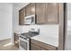 Close-up of kitchen with stainless steel appliances, gas range and ample counter space at 9022 Spaulding St, Parker, CO 80134