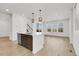 Open-concept kitchen with island, modern appliances, and abundant natural light flowing into the living area at 9022 Spaulding St, Parker, CO 80134