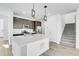 Well-equipped kitchen featuring a large island and stainless steel appliances, next to staircase at 9022 Spaulding St, Parker, CO 80134