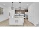 Modern kitchen featuring a large island with pendant lighting and stainless steel appliances at 9022 Spaulding St, Parker, CO 80134