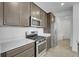 Modern kitchen features stainless steel appliances and neutral-toned cabinets with light countertops at 9022 Spaulding St, Parker, CO 80134