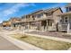 Row of craftsman style homes with covered front porches and stone accents on a sunny day at 9022 Spaulding St, Parker, CO 80134