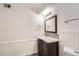 This secondary bathroom features an updated vanity, mirror and lighting at 11937 E Harvard Ave # 102, Aurora, CO 80014
