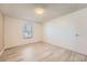 Bright bedroom with neutral walls, wood floors, and window with natural light at 11937 E Harvard Ave # 102, Aurora, CO 80014
