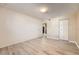 A bright bedroom with natural light, a closet, wood floors, and neutral walls at 11937 E Harvard Ave # 102, Aurora, CO 80014