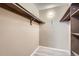 Walk in closet with wood shelving and neutral paint palette at 11937 E Harvard Ave # 102, Aurora, CO 80014