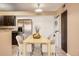 A dining area is staged with a table, chairs, and decor, with stainless steel fridge and washer/dryer unit at 11937 E Harvard Ave # 102, Aurora, CO 80014