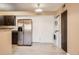 Kitchen includes stainless steel fridge and nearby closeted washer/dryer combo on white floors at 11937 E Harvard Ave # 102, Aurora, CO 80014