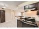 Well-lit kitchen with modern appliances, including a stainless steel range and dark cabinets with stone countertops at 11937 E Harvard Ave # 102, Aurora, CO 80014