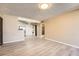 Open living space with wood-look floors, stainless appliances, and laundry area at 11937 E Harvard Ave # 102, Aurora, CO 80014