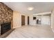 Spacious living area featuring a stone fireplace, open floor plan, and modern finishes at 11937 E Harvard Ave # 102, Aurora, CO 80014