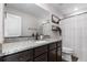 Updated bathroom with granite countertop, dark cabinets, and modern fixtures and decor at 14836 Jersey Dr, Mead, CO 80542