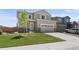 Charming two-story home with a well-manicured lawn and a two-car garage and stone accents at 14836 Jersey Dr, Mead, CO 80542